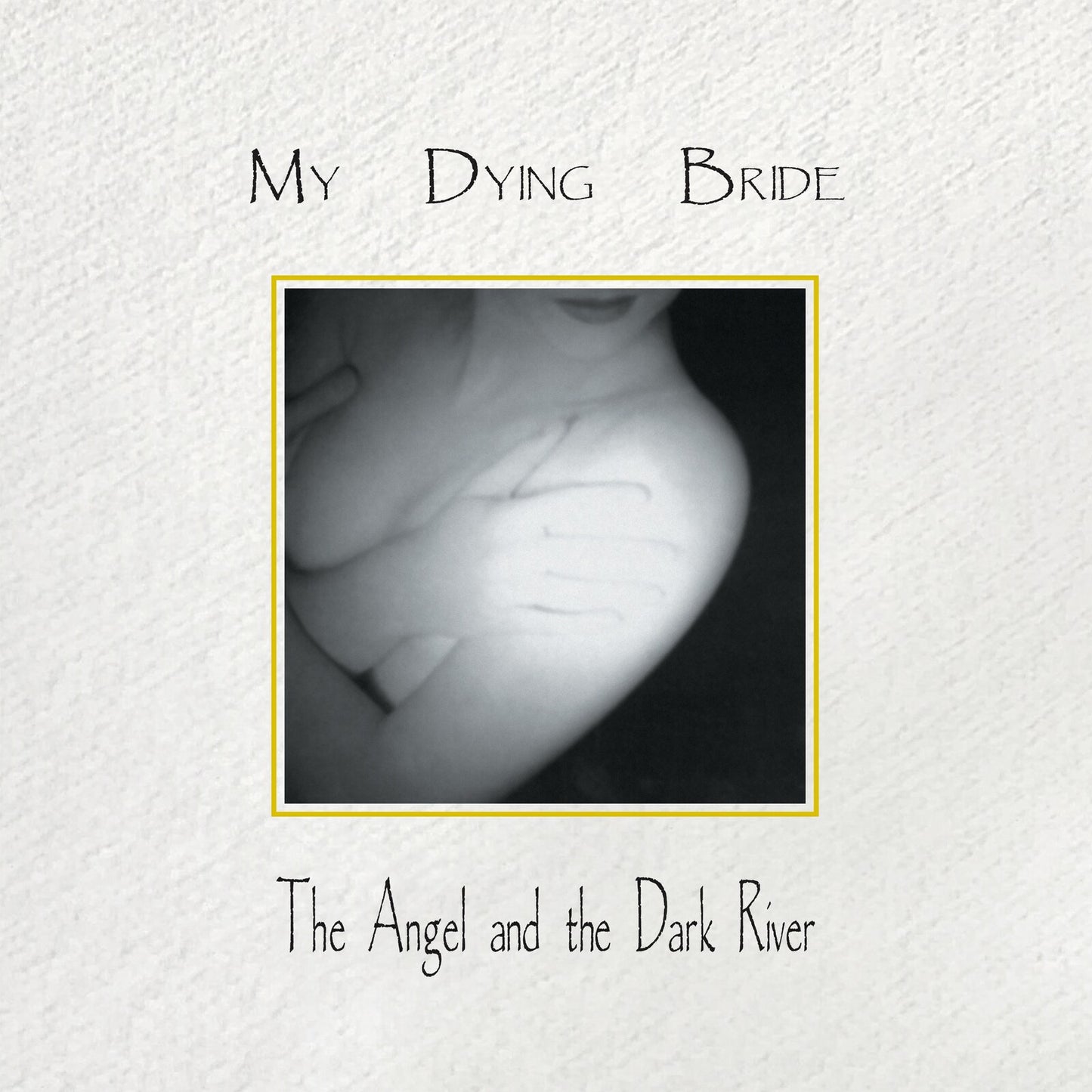 CD cover: grayscale image of a person’s hands with writing, gold border.