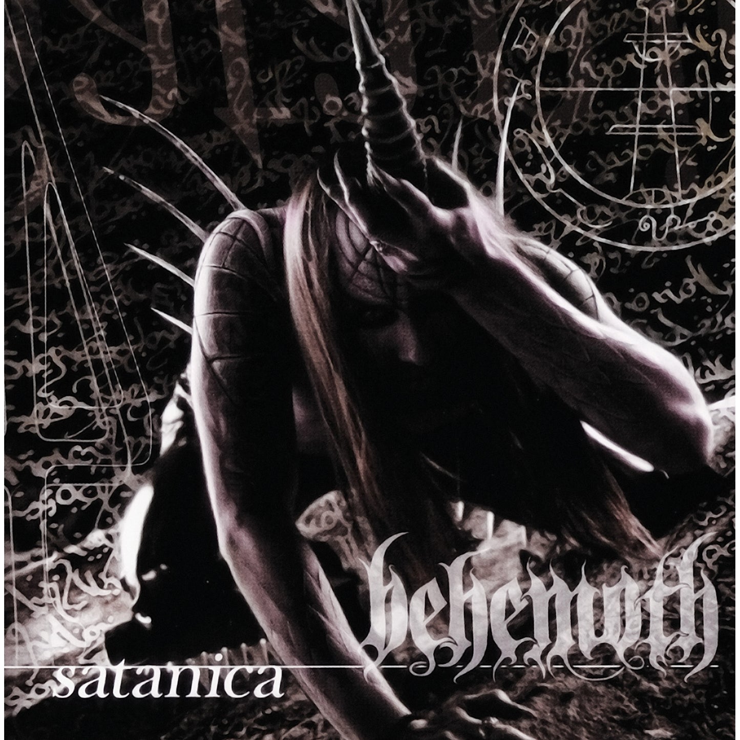 A dark, shadowy figure with a horn on its head against occult symbols.