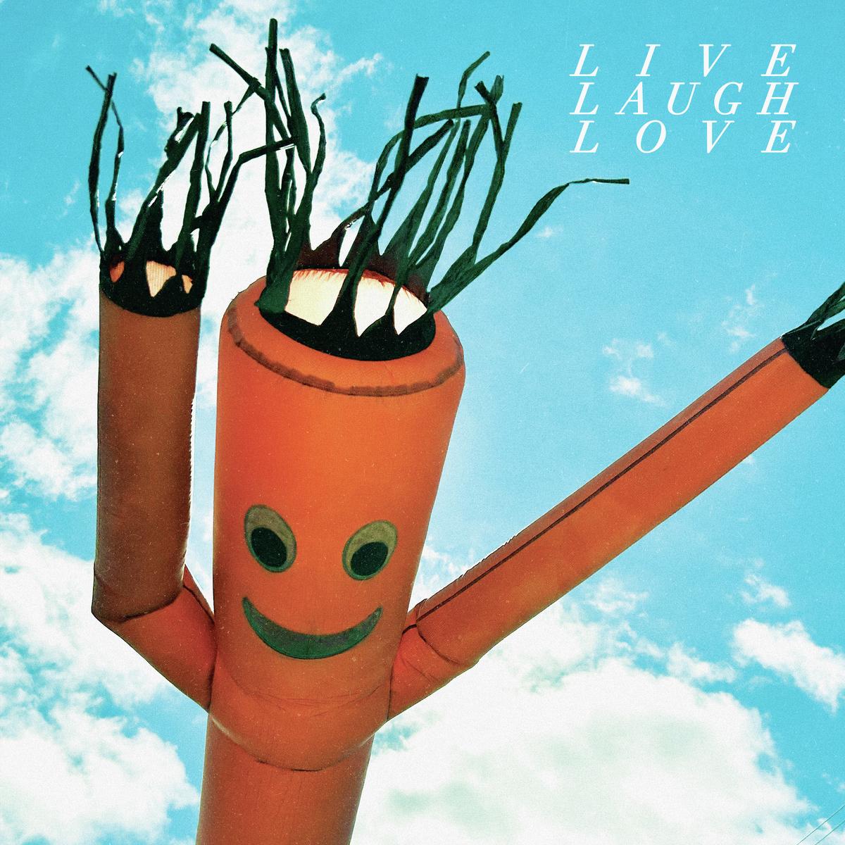 Orange inflatable tube man with a smiling face against a blue sky.