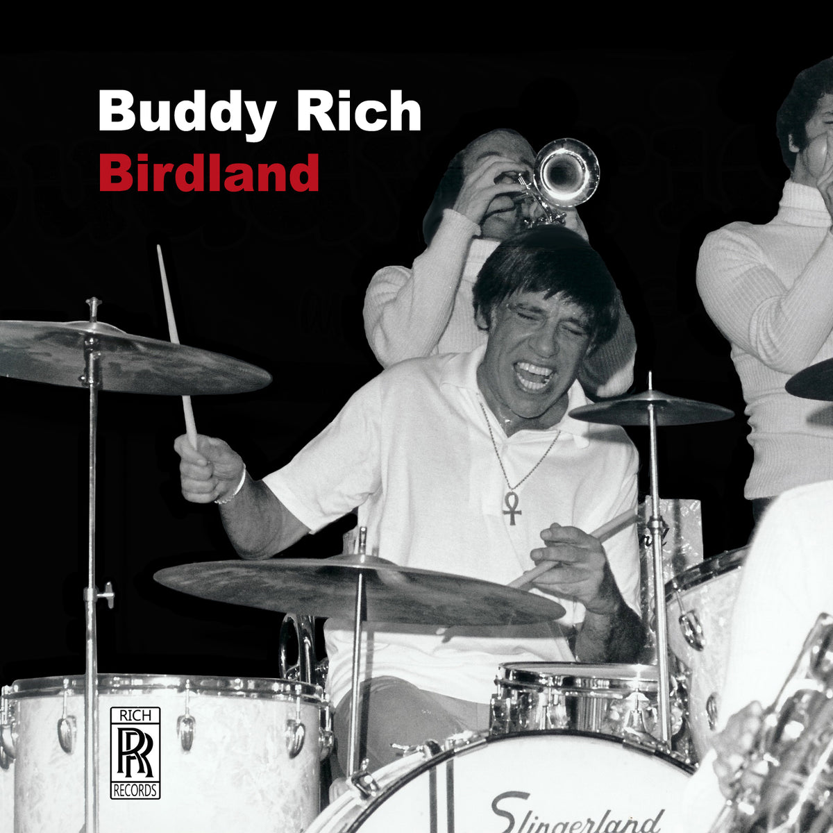 Black and white photo of Buddy Rich intensely playing drums onstage.