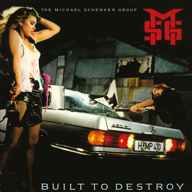 Album cover for The Michael Schenker Group’s “Built To Destroy” featuring a woman and wrecked car.