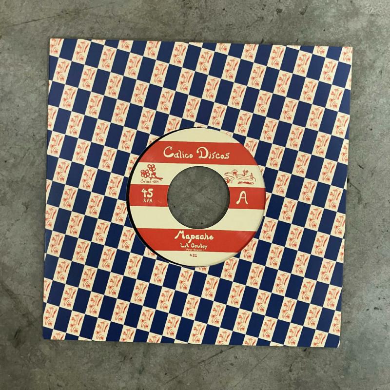 7-inch vinyl record with red and white checkered paper sleeve.