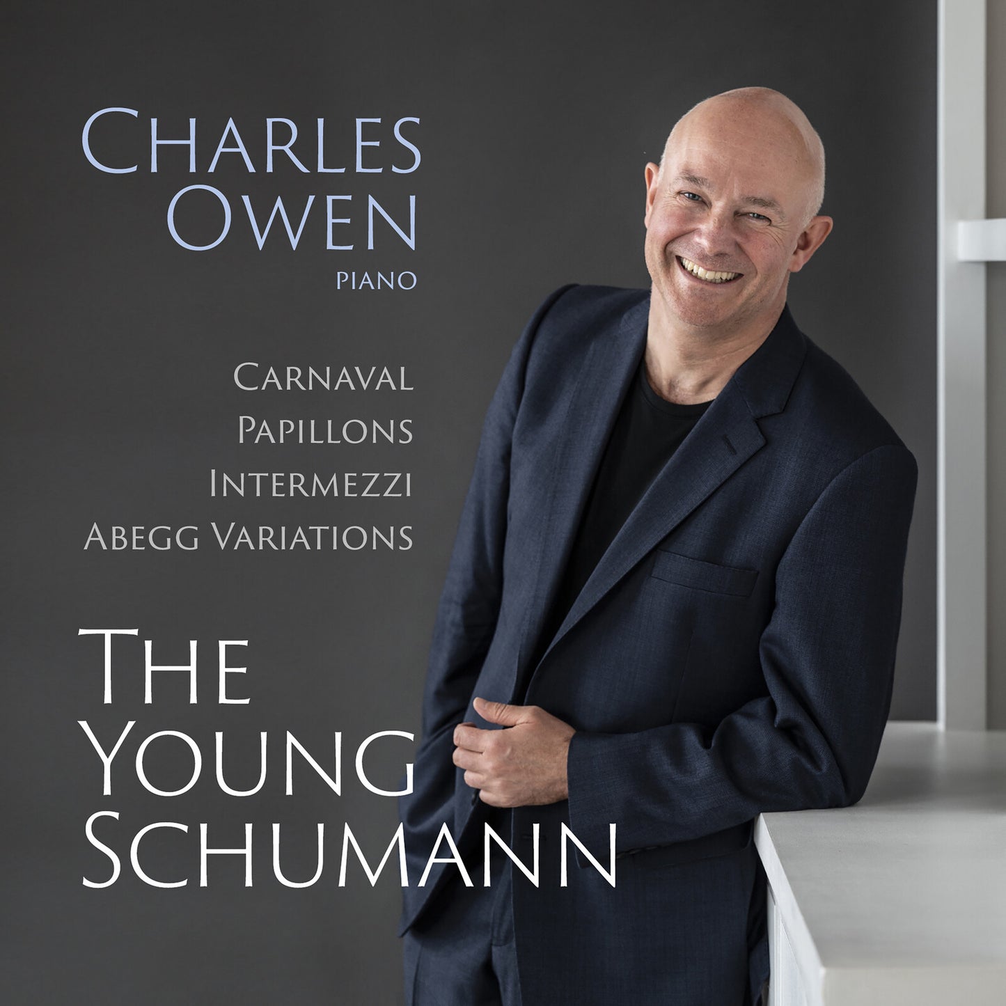CD cover featuring pianist Charles Owen in a dark suit, smiling.