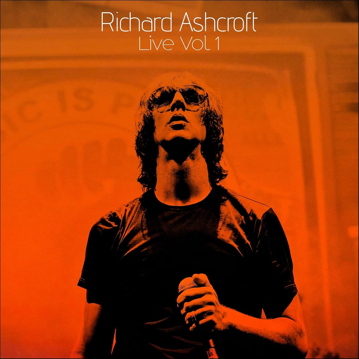 Richard Ashcroft album cover featuring a portrait of the singer with a microphone.