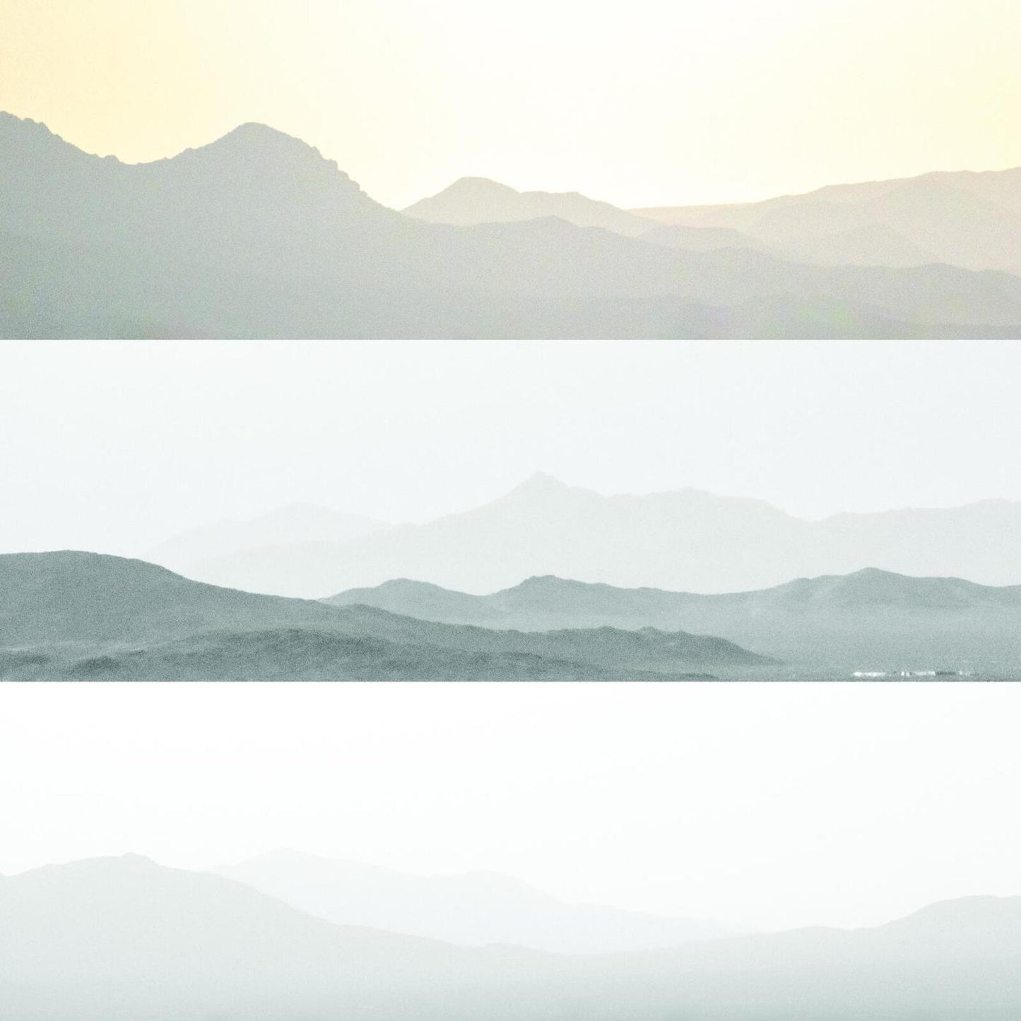 Horizontal bands of layered, hazy mountains in muted greens and whites.
