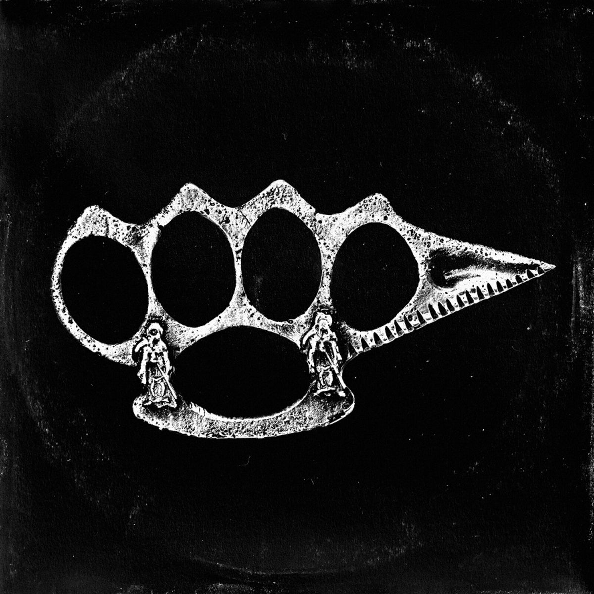 White brass knuckles with figures on a black background.