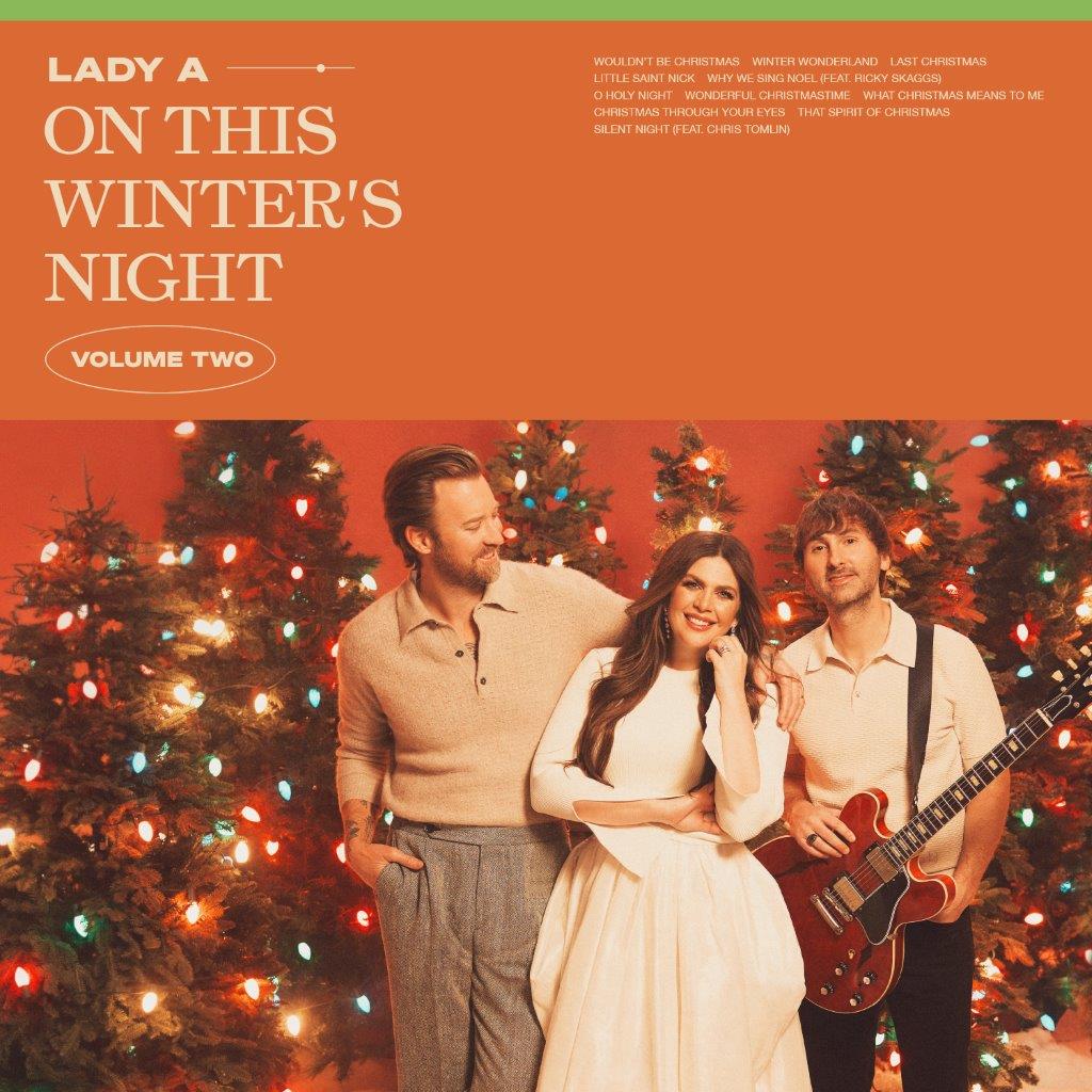 Lady A album cover featuring three people in front of a Christmas tree.
