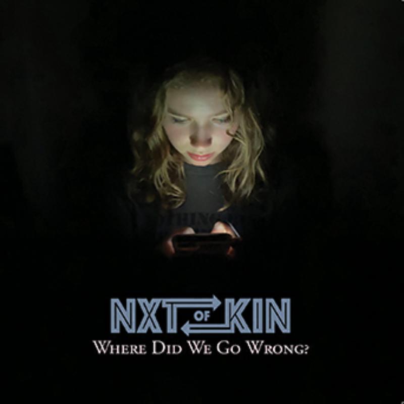 CD cover: young person looking at a glowing phone in darkness.