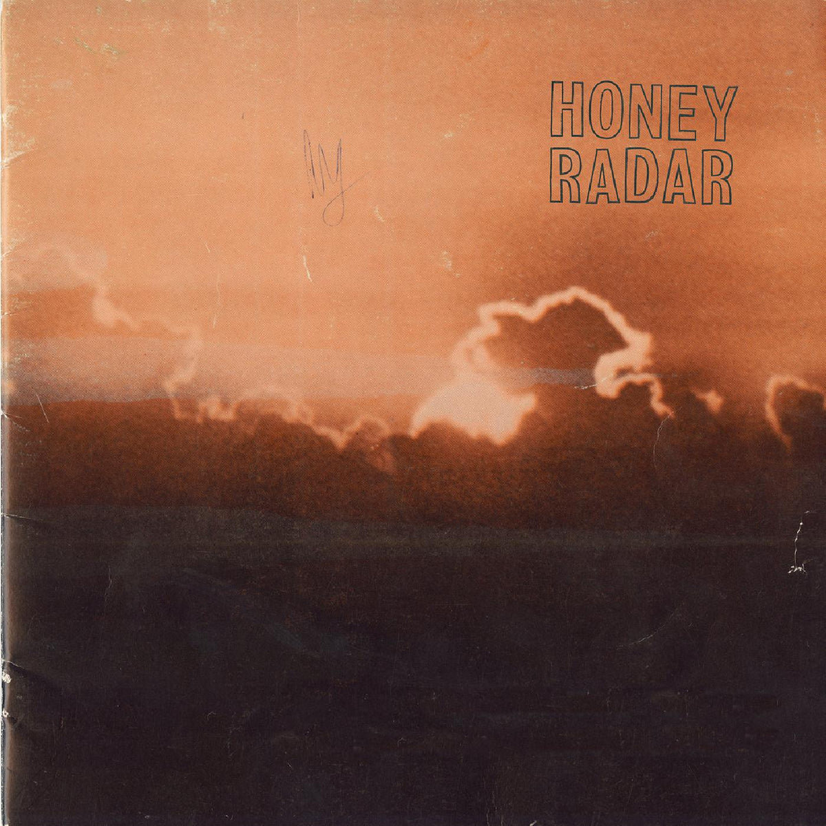 Orange vinyl record cover with clouds and the text "HONEY RADAR".