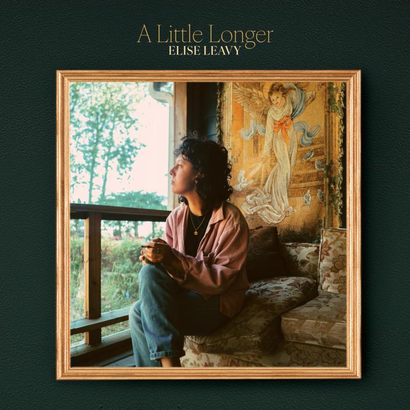 Woman looking out a window, framed album cover for Elise Leavy.