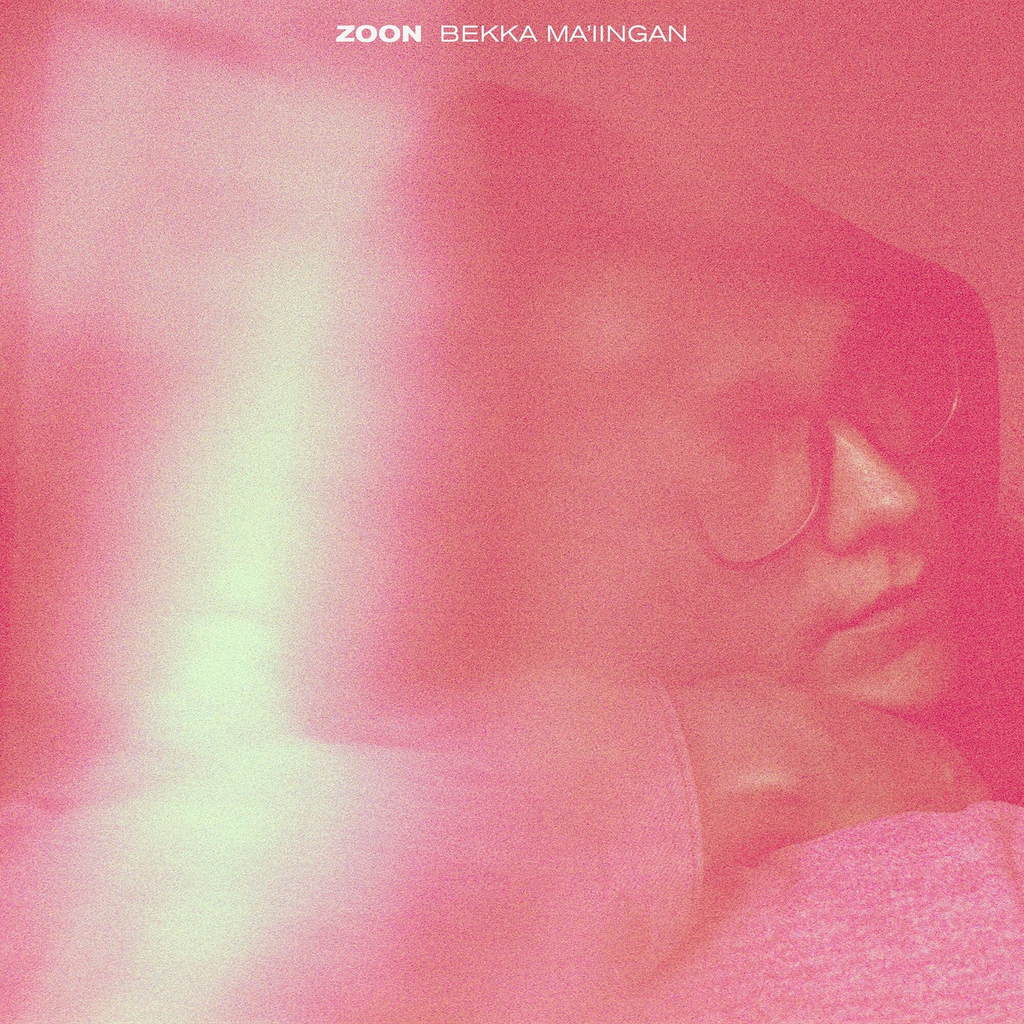 Pink album cover featuring a blurred portrait of a person with sunglasses.