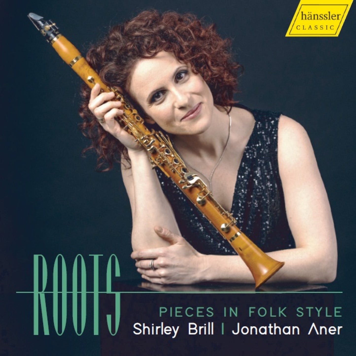 Woman with curly hair holding a wooden clarinet, CD cover art.