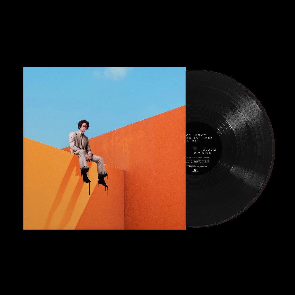 Vinyl record with orange and blue cover featuring a person in a suit.