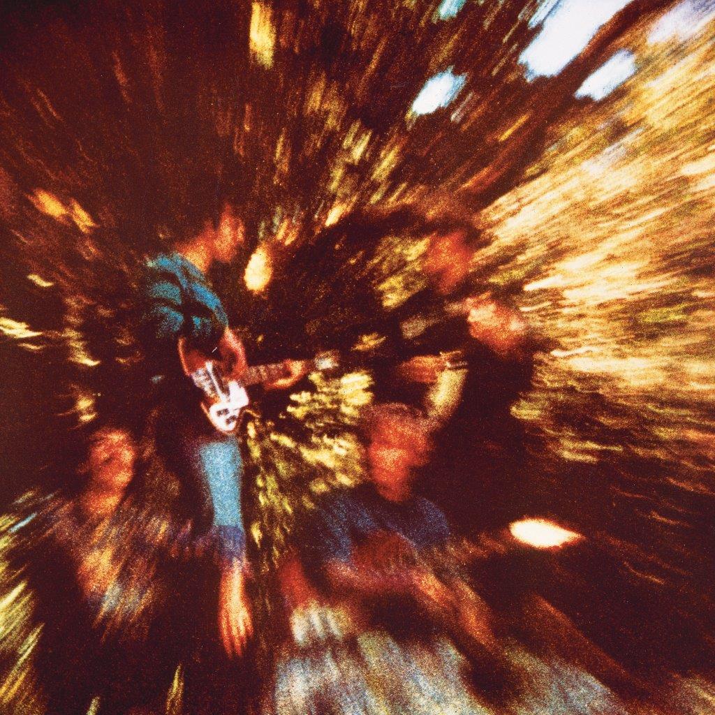 Blurry album cover of Creedence Clearwater Revival playing instruments.