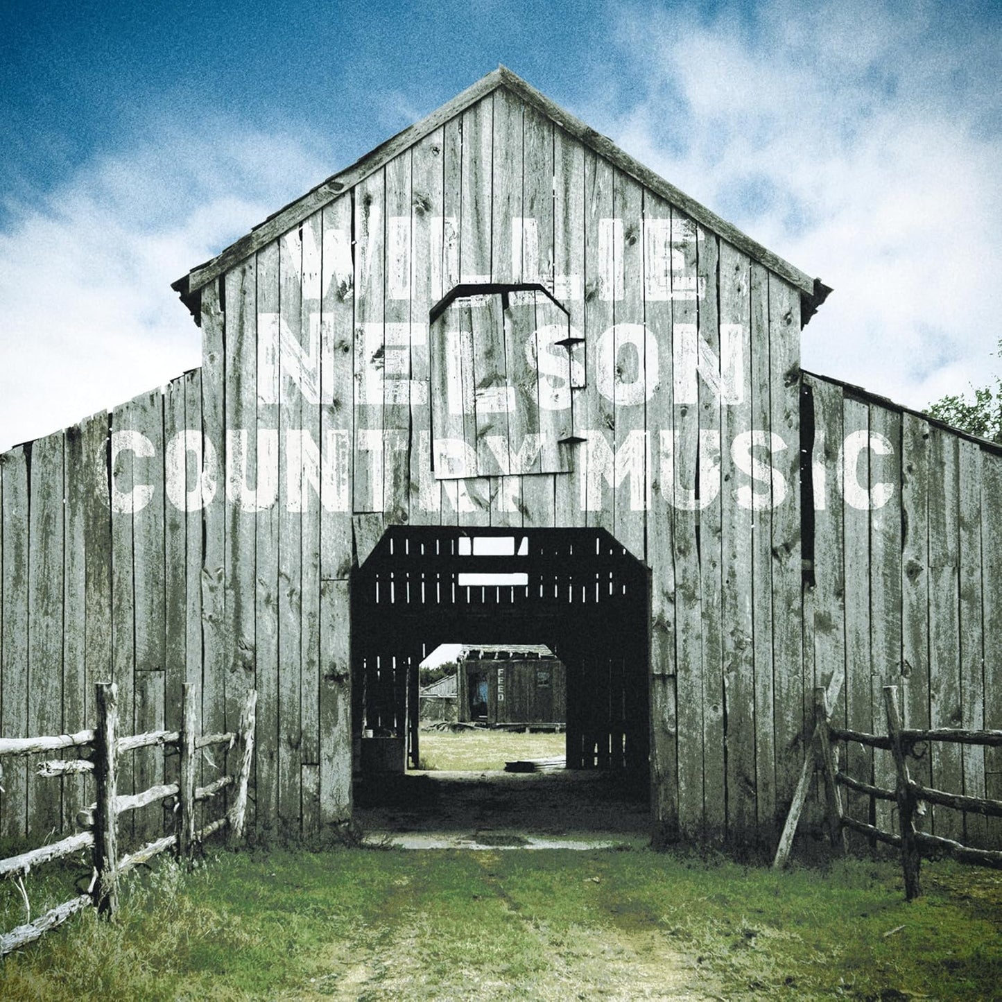 Weathered wooden barn with "Willie Nelson - Country Music" text.