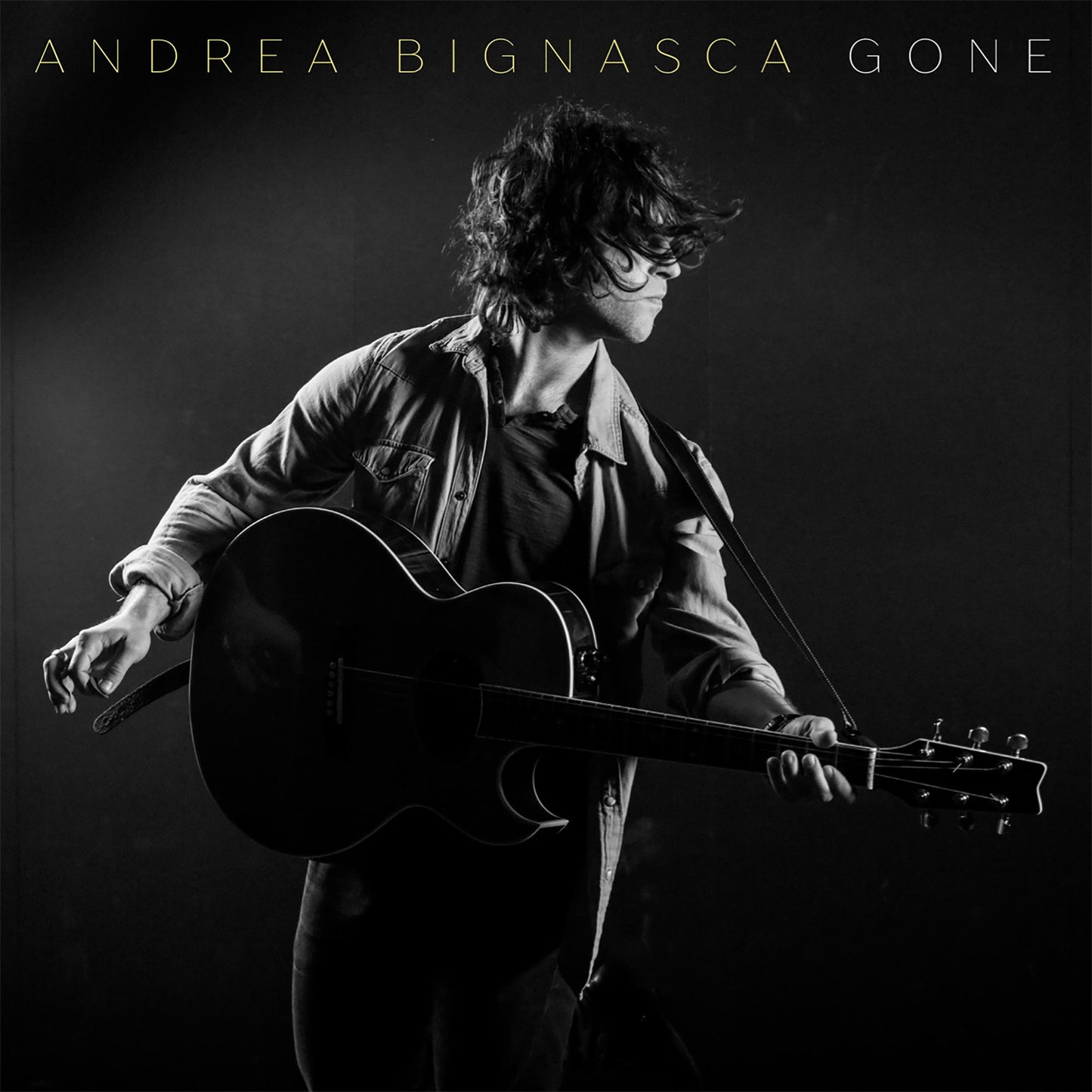 Black and white album cover of a man playing an acoustic guitar.