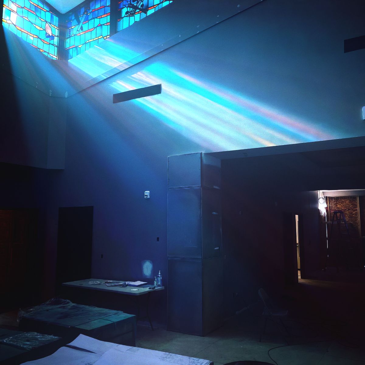 CD cover: blue-toned interior with light beams and minimal furniture.