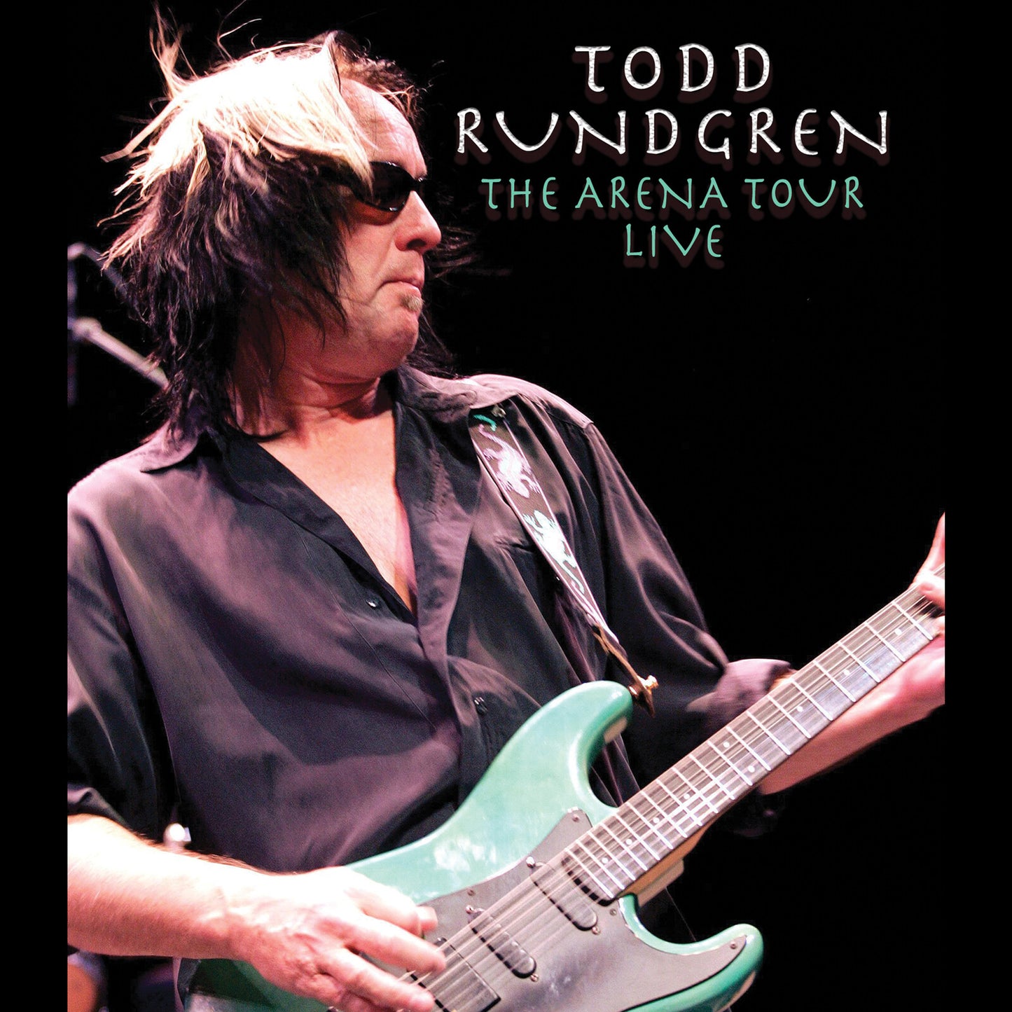 Todd Rundgren playing a teal electric guitar on Blu-ray cover.