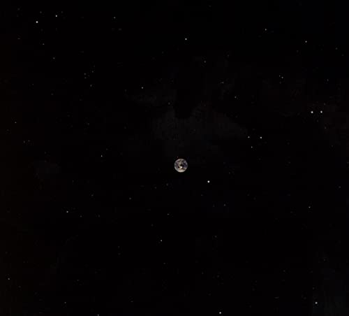Dark image with a small, speckled orb resembling a planet or moon.
