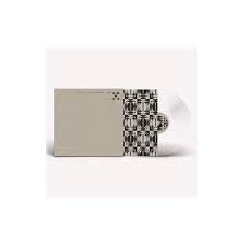 The 1975 album cover and clear vinyl record with geometric pattern.