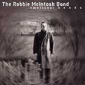 CD cover: Robbie McIntosh portrait in a blurred, grassy field.