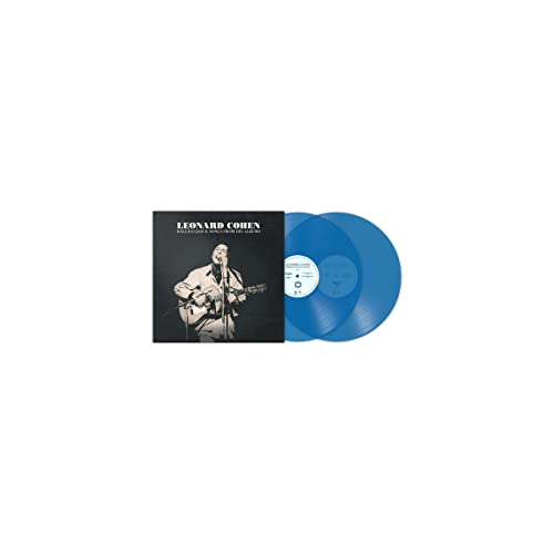 Leonard Cohen album cover next to two blue vinyl records.