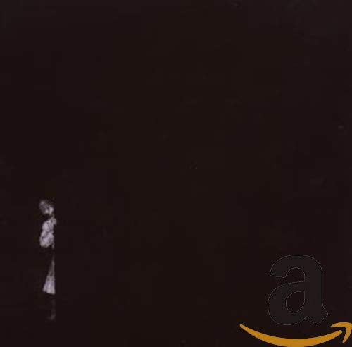 Dark CD cover with a blurry figure and Amazon logo.
