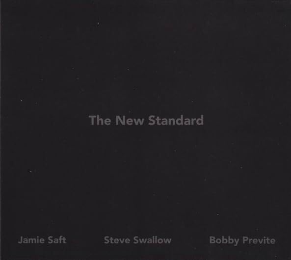 Black album cover with text: "The New Standard" and artist names.