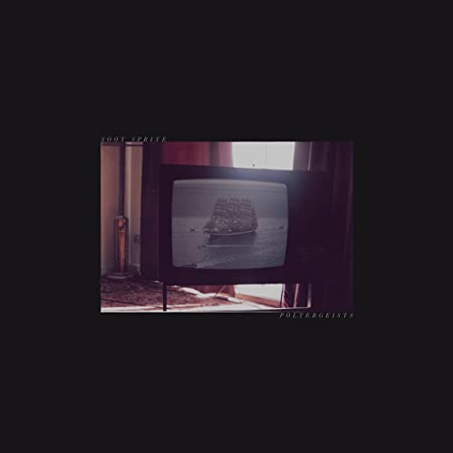 Old television displaying a sailing ship on a dark, muted background.