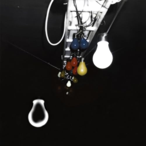 Low-angle view of hanging lightbulbs against a dark ceiling.