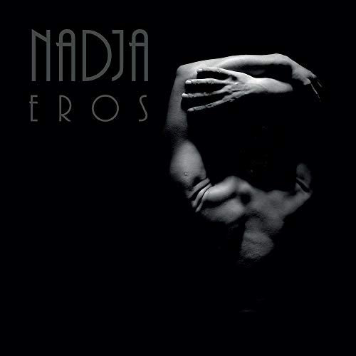 Black and white album cover with a person’s face partially obscured by hands.