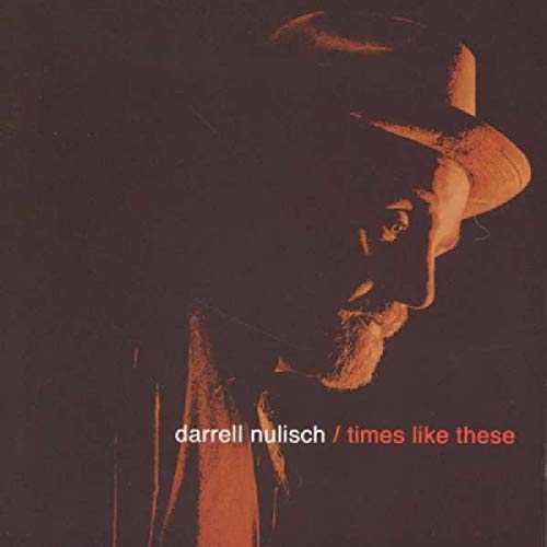 CD cover: profile of a man wearing a hat, dark reddish tones.