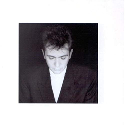 Black and white portrait of Peter Gabriel, looking downward.