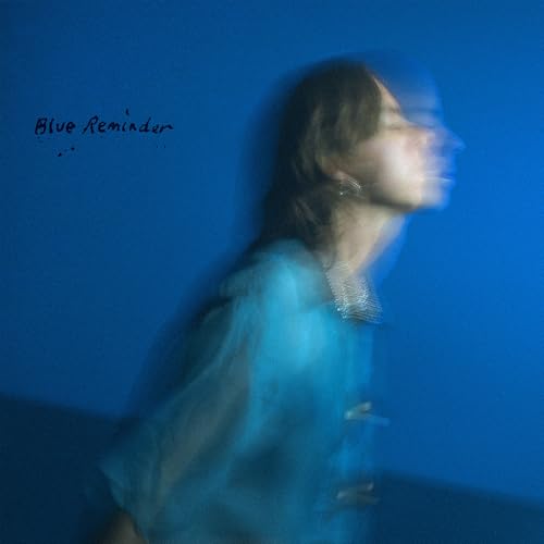 Blurry album cover featuring a woman’s face in blue tones.