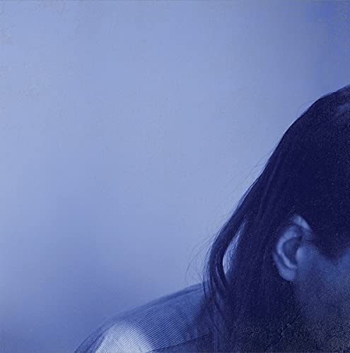 Blue vinyl record cover with a partial portrait of a person.