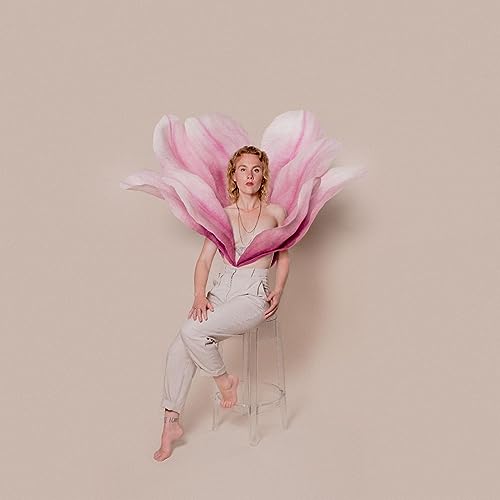 Woman with red hair emerging from a large pink magnolia flower.