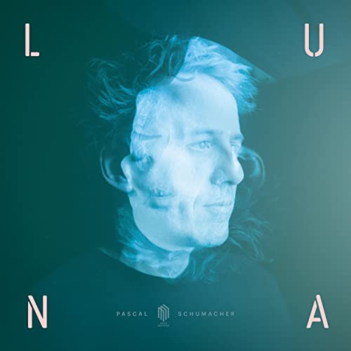 Blue-toned portrait of Pascal Schumacher with blurred, ghostly effect.