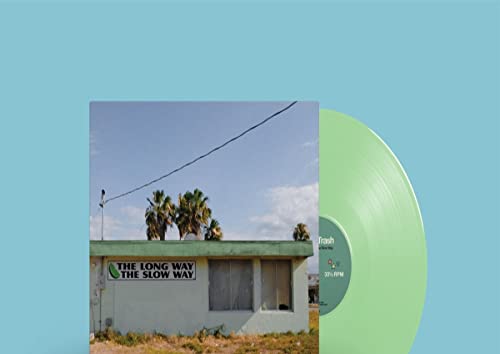 Vinyl record with green tint, album cover showing a building and palms.