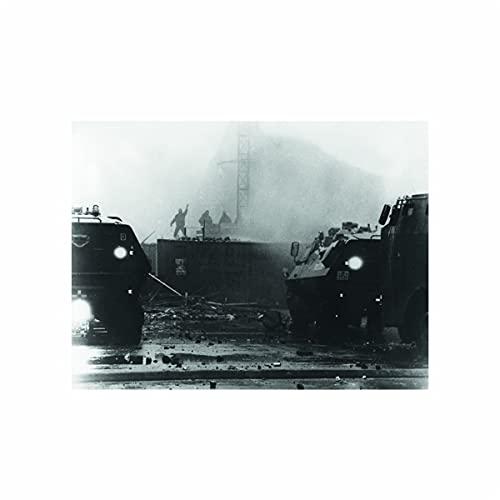 Black and white image of armored vehicles and figures near debris.
