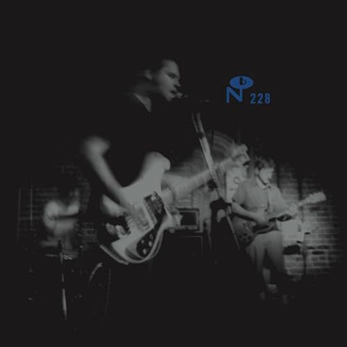 Black and white photo of a band performing on stage.