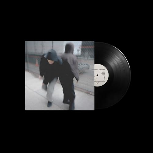Vinyl record with cover art depicting two figures running outdoors.