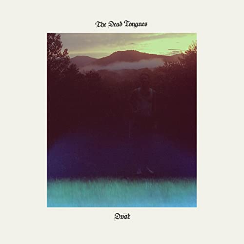 CD cover: person standing in a field with mountains in the background.