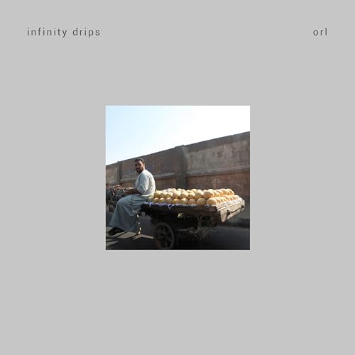 Album cover: man with melons on a cart, brick building backdrop.