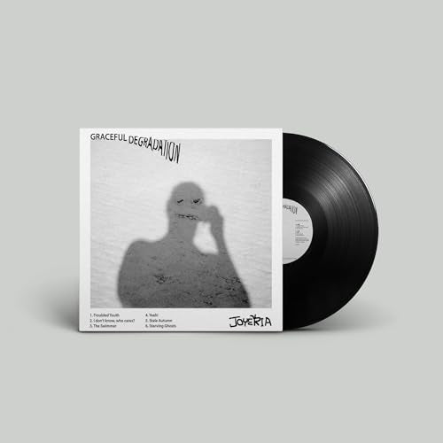 Vinyl record with white album cover featuring a shadowy figure.