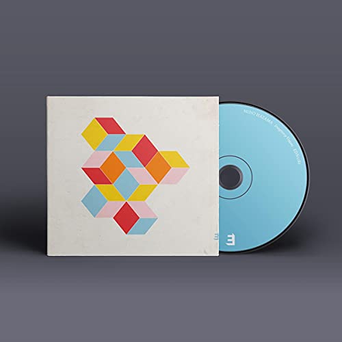 CD case and disc with abstract geometric cube design in bright colors.