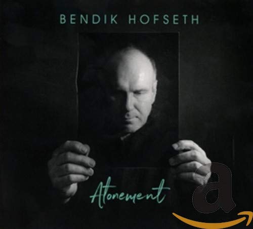 Black and white album cover featuring a man holding a framed portrait.