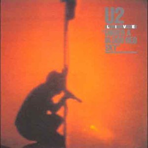 U2 album cover: silhouette of a singer against a fiery orange sky.