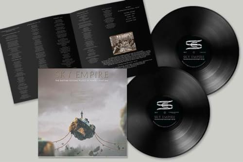 Two black vinyl records with album artwork and open booklet displayed.