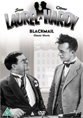 Black and white image of two men in suits looking at each other.