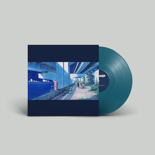 Vinyl record with album cover depicting a blue-toned street scene.